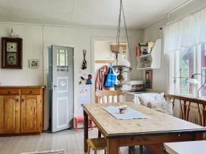 a kitchen with a wooden table and a dining room at Holiday home MARIESTAD XI in Mariestad