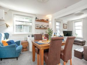 a living room with a dining room table and chairs at Captains Lockyer in Kingswear