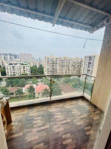 a large window in a room with a view of a city at kolte patil 24k allura in Pune