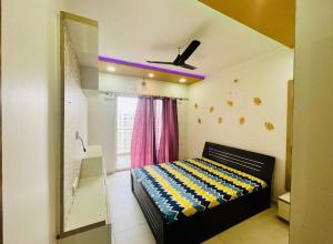 a bedroom with a bed and a mirror and a window at kolte patil 24k allura in Pune