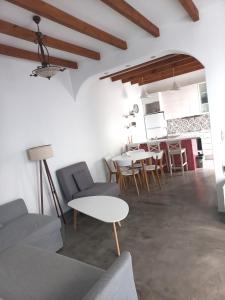 a living room with a couch and a table at Stella' s house Castle of Chora Naxos in Naxos Chora