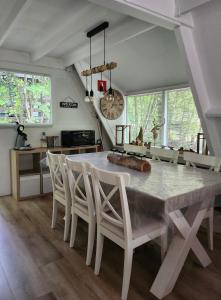 a dining room with a table and chairs at Het Hertenbos chalet 136 in Durbuy