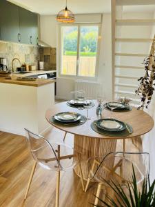 a kitchen with a wooden table with glasses on it at Maison Evasion Voyage parking et jardin by Art de Voyager in Étretat