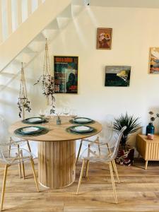 a dining room with a table and chairs at Maison Evasion Voyage parking et jardin by Art de Voyager in Étretat