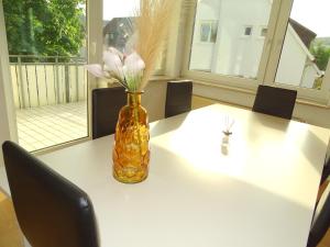 a vase with flowers in it sitting on a table at Zentrale 3,5 Zimmer Wohnung bis zu 6 Personen in Rudersberg in Rudersberg