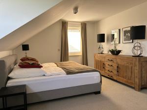 a bedroom with a bed and a dresser at Romantikchalet Neuastenberg/Winterberg in Winterberg
