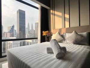 吉隆坡的住宿－Axon Luxury Suites KL，一张位于带大窗户的房间内的床铺