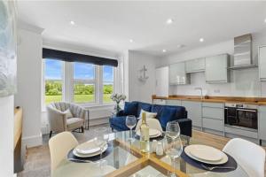 a kitchen and living room with a table and chairs at Ahoy There! in Hythe