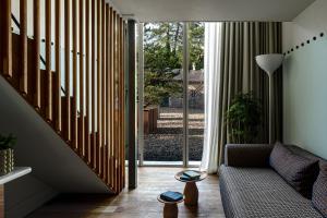a living room with a couch and a staircase at Cowley Manor Experimental in Cheltenham