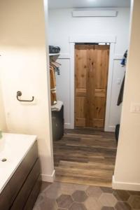 a bathroom with a sink and a wooden door at The “Worst” Home, Best Stay In Pagosa Springs in Pagosa Springs