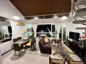 a living room with a zebra rug and a table at Flat 414 Condominio Villa Hípica - Gravatá PE in Gravatá