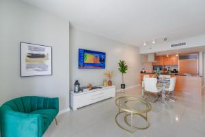 un soggiorno con tavolo e sedie e una cucina di Luxurious 1/1 Condo at Icon Brickell W/Pool a Miami