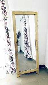 uno specchio con struttura in legno in una stanza di Cozy Apartment in the City Centre - Rayfield Jos a Zawan