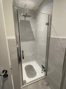 a shower with a glass door in a bathroom at Luxury Spring Stays Lichfield City Centre 2 Bedroom Apartment With Free Secure Parking in Lichfield