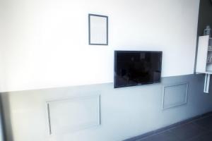 sala de estar con TV en la pared en Charmantes Studio Apartment in Bestlage im Stadtzentrum mit Balkon & self checkin - City Loft 3 -, en Colonia