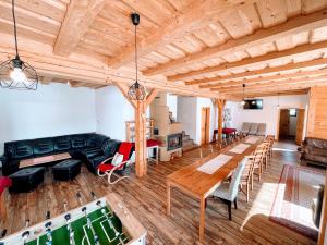 a large living room with a pool table at Holiday Home Holiday Raj in Bešeňová