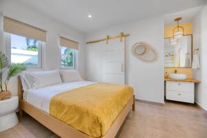 a bedroom with a bed and a bathroom with a sink at Entire Villa - 7br Pool Sun Deck Ocean Park in San Juan