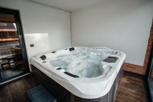 a jacuzzi bath tub in a room with at Pensiunea VOX in Moisei