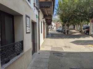 an empty street next to a building with a sidewalk at Apartamento Rural Zahora in Hervás