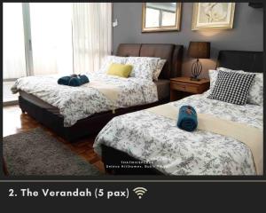 a bedroom with two beds and a couch and a room with at ThatNicePlace, Selesa Hillhomes, Bukit Tinggi, Janda Baik, Genting in Bentong +45 photos