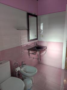 a bathroom with a white toilet and a sink at Casa rural La Gata in Campillo de Ranas