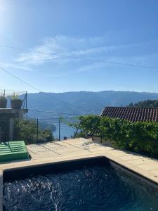 a swimming pool with a view of the water at Casa da Lage - Gerês in Vieira do Minho