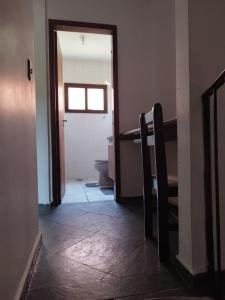 Un pasillo con una puerta a un baño con inodoro. en Guarujá, Linda casa em condomínio fechado ., en Guarujá 10 fotos más