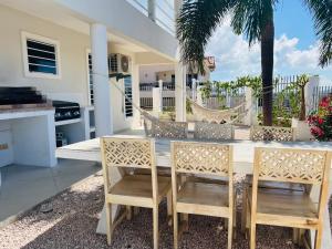 a dining room with a table and two chairs at Apartment in luxury villa with private pool in Willemstad