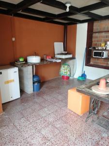 a kitchen with a counter and a refrigerator in a room at "La Casa del Abuelo" in Santa Ana