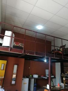 ajar view of a loft bed in a room at "La Casa del Abuelo" in Santa Ana