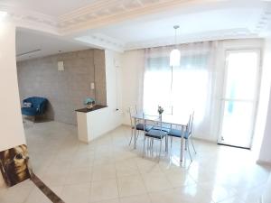 uma cozinha e sala de jantar com mesa e cadeiras em Chambre privative dans un appartement partagé em Casablanca