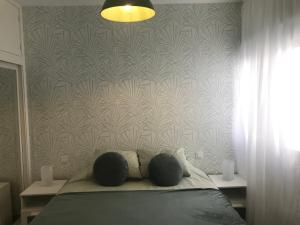 a bedroom with a bed with two pillows on it at Paraíso playero en Las Palmas in Las Palmas de Gran Canaria