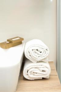 a stack of towels on a toilet in a bathroom at Villa Ema in Pale +31 photos