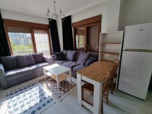 a living room with a couch and a table at Maltepe, Cevizli cozy apt in Istanbul