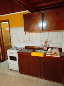 a kitchen with a stove and a sink at Cabañas Monik in El Calafate