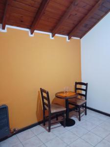 a dining room with a table and two chairs at Cabañas Monik in El Calafate