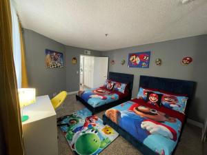 a childs bedroom with two beds and a table at Hollywood Apartment One Bedroom with Mario in Los Angeles