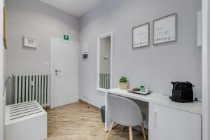 a white room with a desk and a chair at Colonna Luxury Suites in Rome