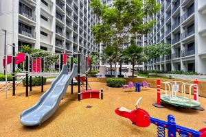 a playground with different kinds of play equipment in a building at 2 Side-by-Side P00L Front Condos, 6 Beds, 2 CR, 2 Kitchen for 10 Guests at MOA in Manila