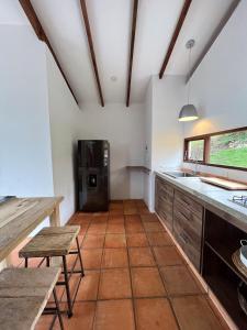 a kitchen with a sink and a refrigerator at Despierte con la naturaleza in Cogua