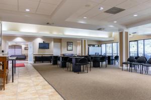 a large room with black chairs and tables and windows at Legacy Vacation Resorts Kissimmee & Orlando - Near Disney in Kissimmee