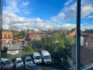 a group of cars parked in a parking lot at Pinner apartments in Pinner