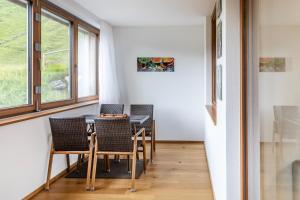 a dining room with a table and chairs and a window at Berg Aparts Faschina - 03 - b42790 in Fontanella