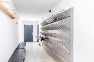 a hallway with a row of stainless steel knives on the wall at Berg Aparts Faschina - 09 - in Fontanella