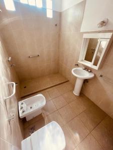 a bathroom with a sink and a toilet at Villa Tequila - Casa Jalisco in Alta Gracia