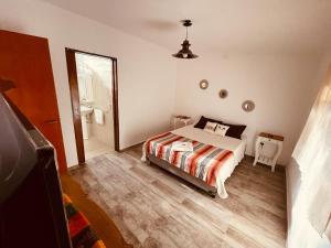 ein Schlafzimmer mit einem Bett und einem großen Spiegel in der Unterkunft Villa Tequila - Casa Jalisco in Alta Gracia
