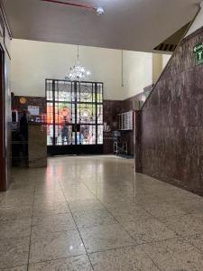 a large empty room with a large window and a large room with a unintention at Studio 112 Campinas SP in Campinas