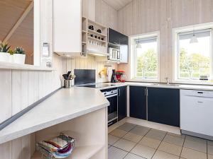 een keuken met witte kasten en blauwe apparatuur bij 10 person holiday home in Rudk bing in Spodsbjerg