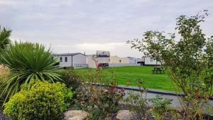 a view of a garden with houses in the background at Lyons Robin Hood Holiday Park, The Shamrock Way in Meliden