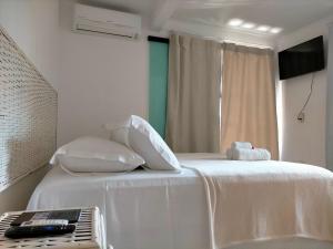 מיטה או מיטות בחדר ב-Itacaré Flats